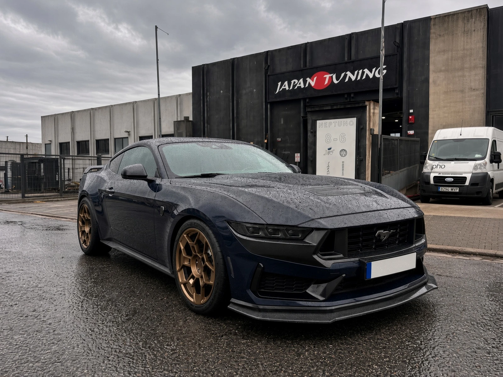 Mustang S650 Dark Horse azul oscuro con llantas bronce de 20 pulgadas frente al taller